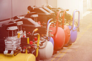 Multiple different colored air compressors in El Paso.