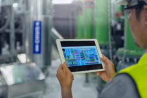 A person looking at an industrial air system layout on a tablet in El Paso.